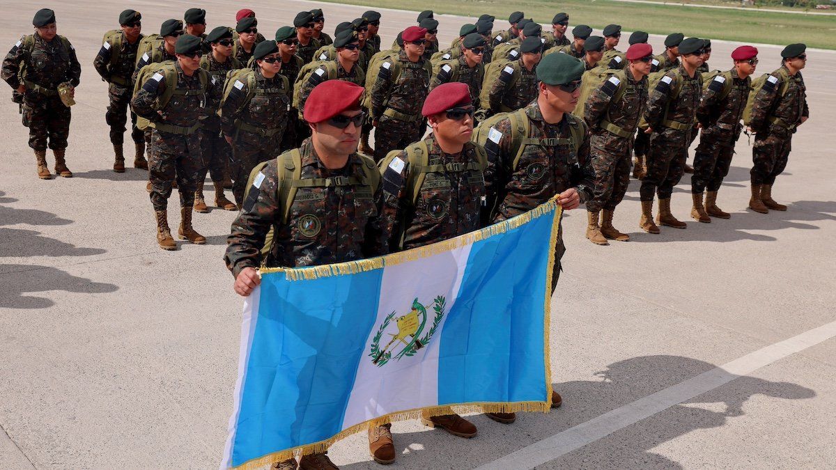 ​A contingent of security forces from Guatemala holds a Guatemala flag as they arrive in Haiti for a security mission, at Toussaint Louverture International Airport in Port-Au-Prince Haiti January 4, 2025. 