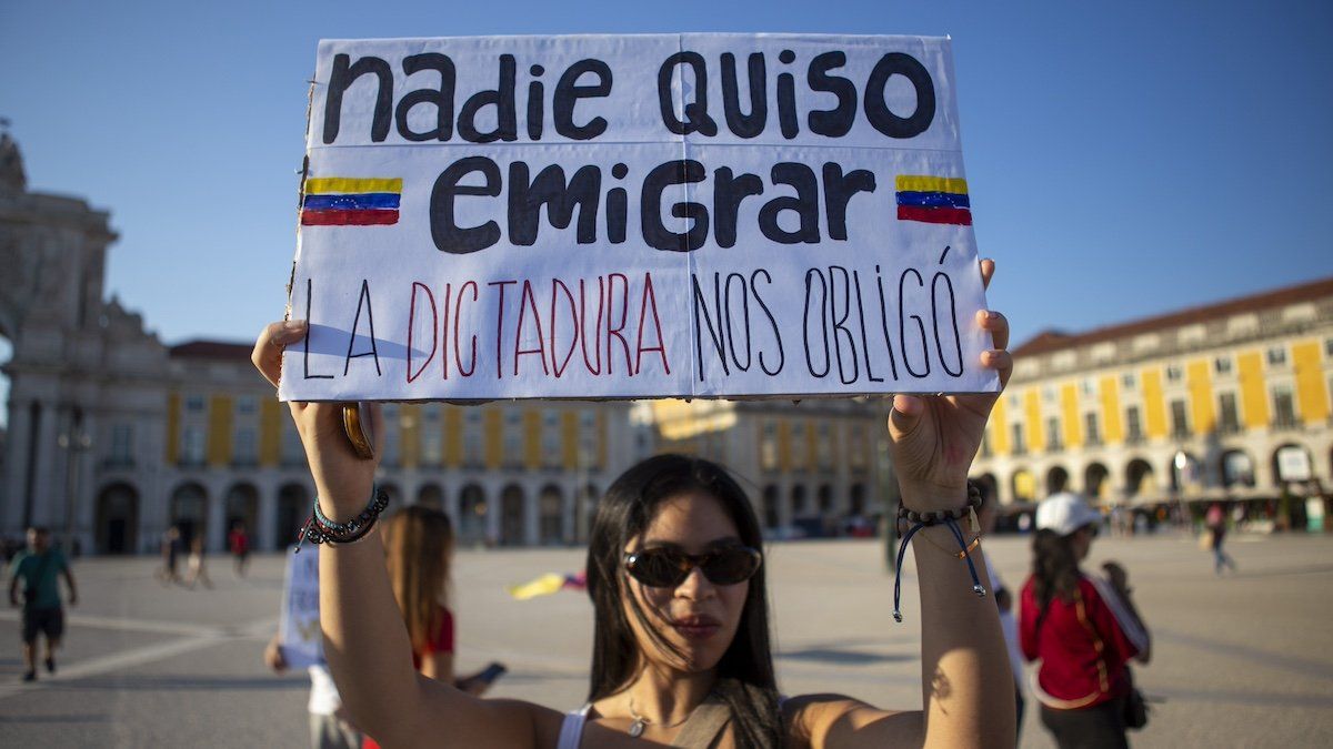 A demonstrator is holding a banner during an antigovernment protest in Lisbon, Portugal, on August 4, 2024. Venezuelans in Lisbon are gathering in Praca do Comercio to protest and express their disagreement with the election results in Venezuela and to support opposition leader Maria Corina Machado and opposition candidate Edmundo Gonzalez.