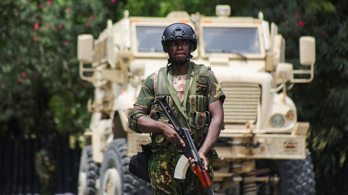 A Kenyan police officer walks in front of an armored personnel carrier during a joint operation with Haitian police, in Port-au-Prince, Haiti July 29, 2024. 