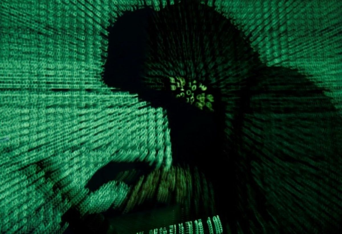 A man holds a laptop computer as cyber code is projected on him in this illustration.