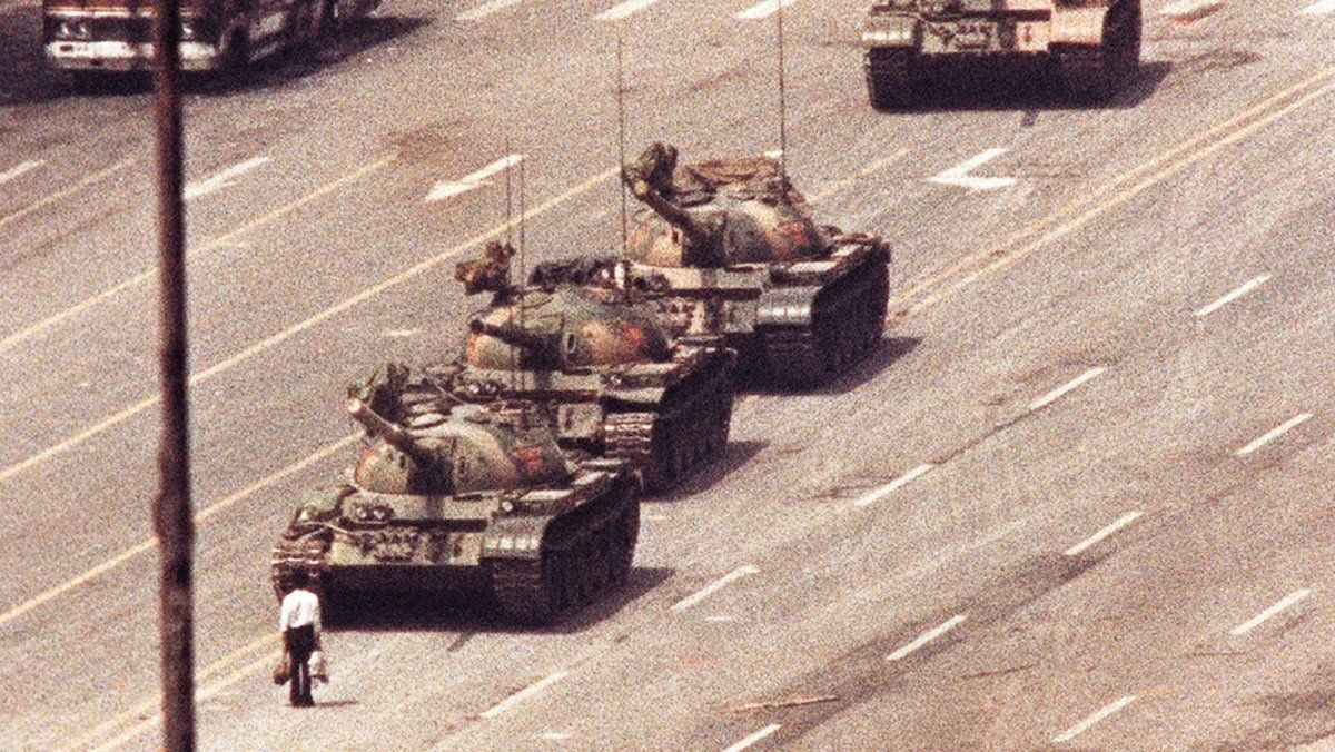 A man stands in front of a convoy of tanks in the Avenue of Eternal Peace in Beijing, June 5, 1989.