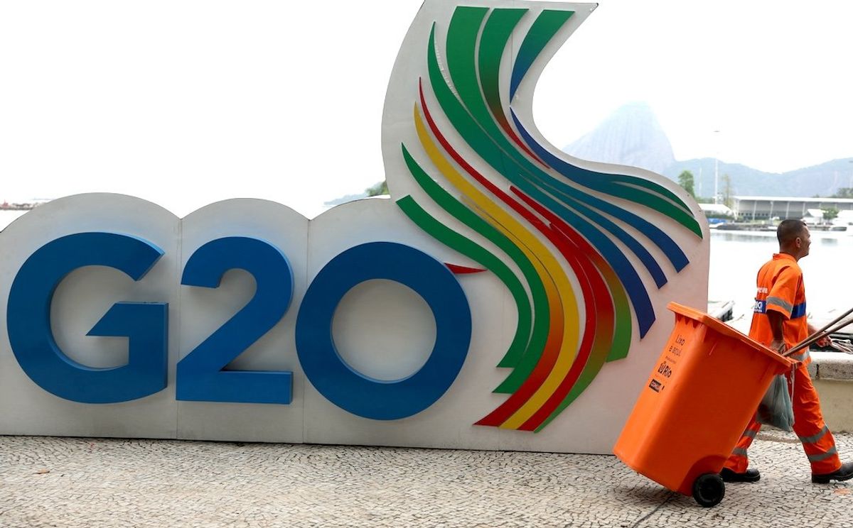 ​A member of the cleaning crew walks past a G20 Summit sign outside the Museum of Modern Art, the venue of the G20 summit, in Rio de Janeiro, Brazil, on Nov. 14, 2024. 