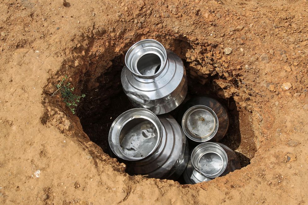 a photograph of water cans inside a hole