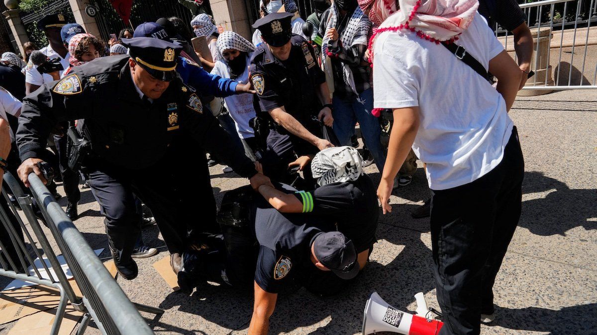 A pro-Palestinian protester is detained by NYPD officers outside of Barnard College on the first day of the new semester, in New York City, U.S., September 3, 2024. 