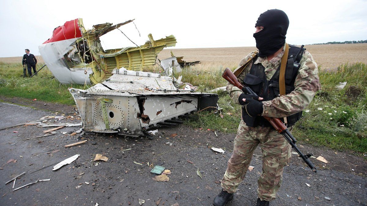 A pro-Russian separatist stands at the crash site of Malaysia Airlines flight MH17, near the settlement of Grabovo in the Donetsk region, July 18, 2014. 