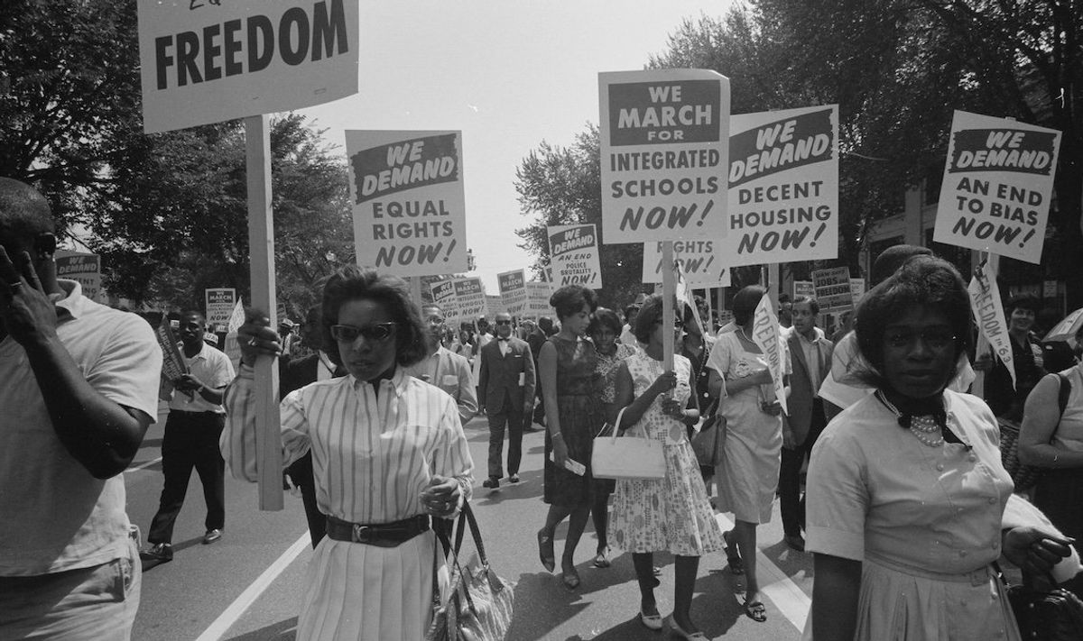 A procession carrying signs for equal rights, integrated schools, decent housing, and an end to bias during the civil rights march in Washington, DC, on Aug. 28, 1963. 