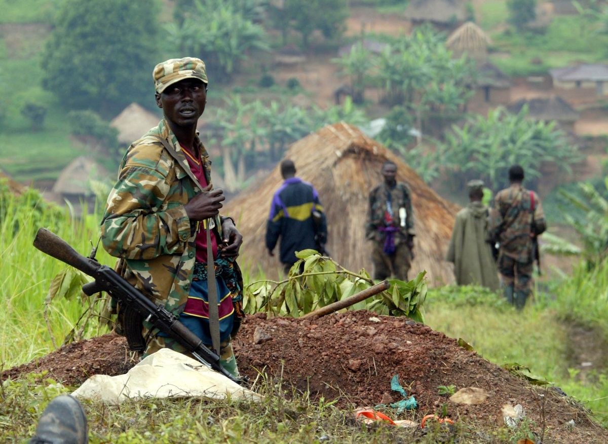 A renegade Congolese soldier stands at an outpost in Eastern Congo deserted town of Kanyabayonga December 16, 2004 which is deserted due to clashes in the area. The Democratic Republic of Congo has replaced its army commander in the eastern province of North Kivu, the scene of days of fighting between government reinforcements and rebel units, authorities said. 