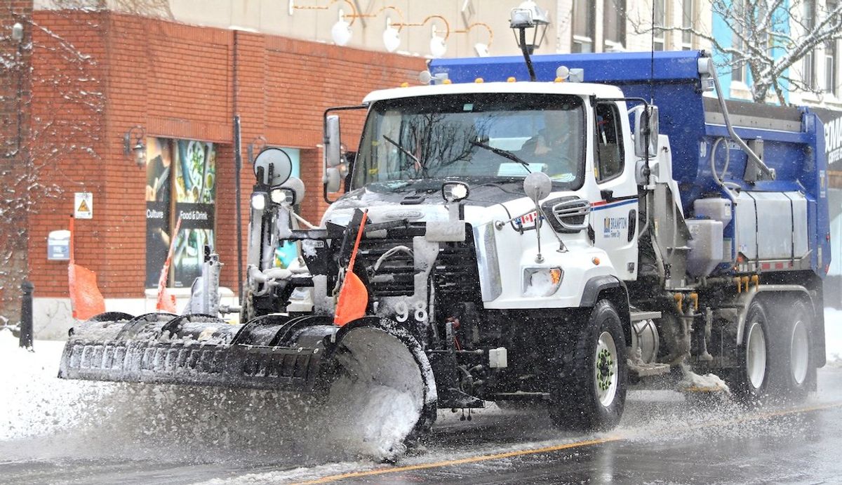 ​A snow plow clears the road along Main Street in downtown Brampton, Ontario, on Jan. 2, 2025. 