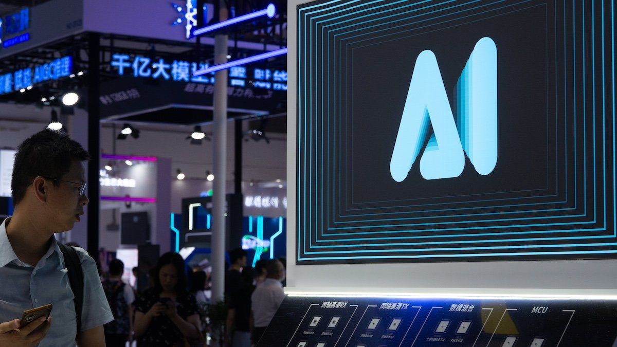 A visitor is walking past an AI sign at the World Artificial Intelligence Conference at the Shanghai World Expo Exhibition Center in Shanghai, China, on July 6, 2024. 