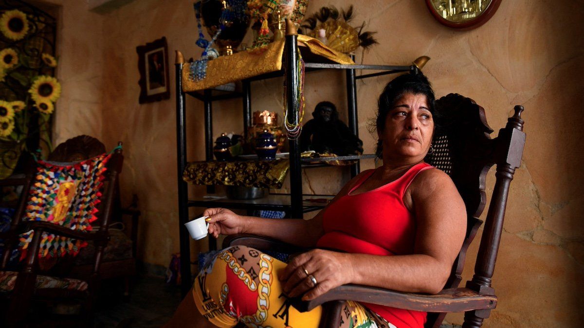 ​A woman sitting at her house, looks on as Cuba suffers a third major setback in restoring power to the island, with millions still without electrical service, in Havana, Cuba, October 20, 2024. 