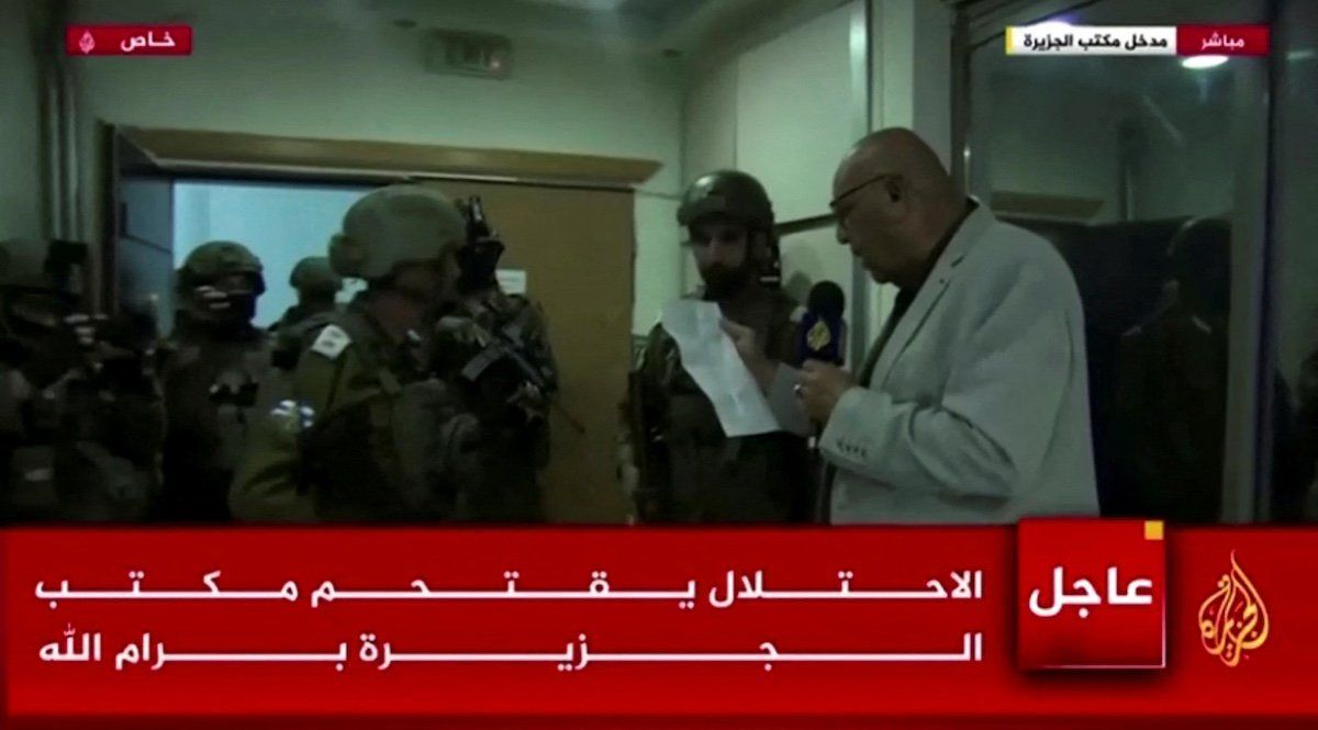 ​Al Jazeera's bureau chief in Israel and the Palestinian Territories, Walid al-Omari, reads from military order papers that were handed to him by Israeli soldiers at the Al Jazeera office in Ramallah, in the Israeli-occupied West Bank, September 22, 2024 in this screen grab from video. 