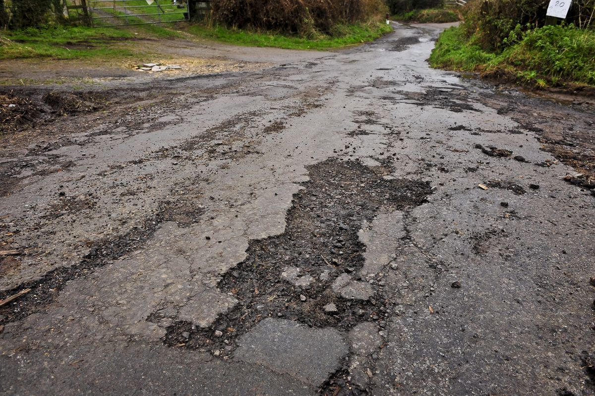 An eroded road surface on a country road in Gloucestershire as many roads in the South West are in need of repair and resurfacing work after a year of heavy rainfall and recent flooding, creating potholes and debris.