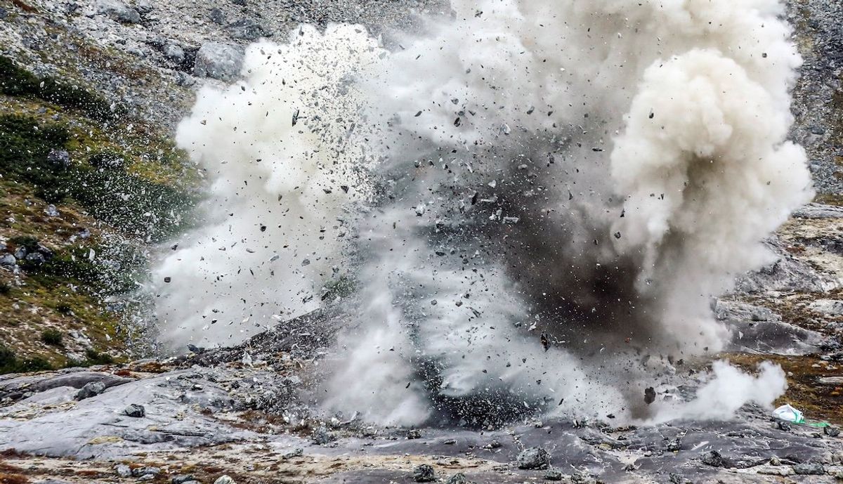 ​An explosion is pictured at an exploration site of the company Greenland Anorthosite Mining of an anorthosite deposit close to the Qeqertarsuatsiaat fjord, Greenland, on Sept. 11, 2021. 