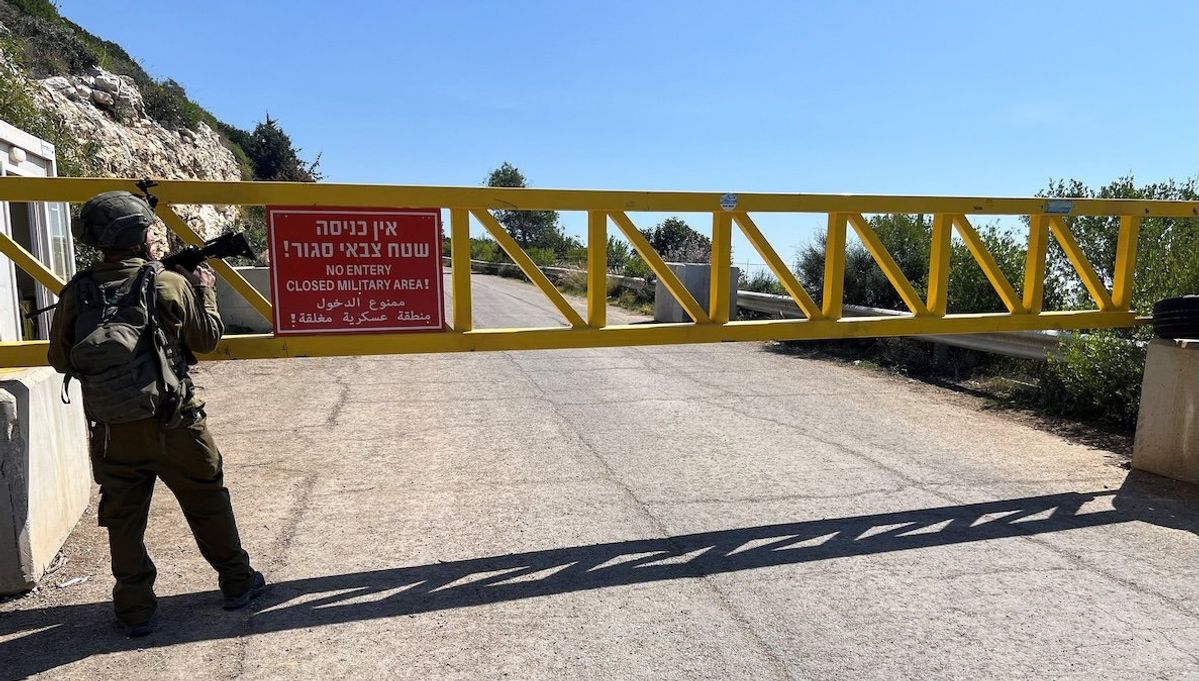 An Israeli soldier stands next to a gate on a road near the Israel-Lebanon border, in Israel, on March 12, 2025.​