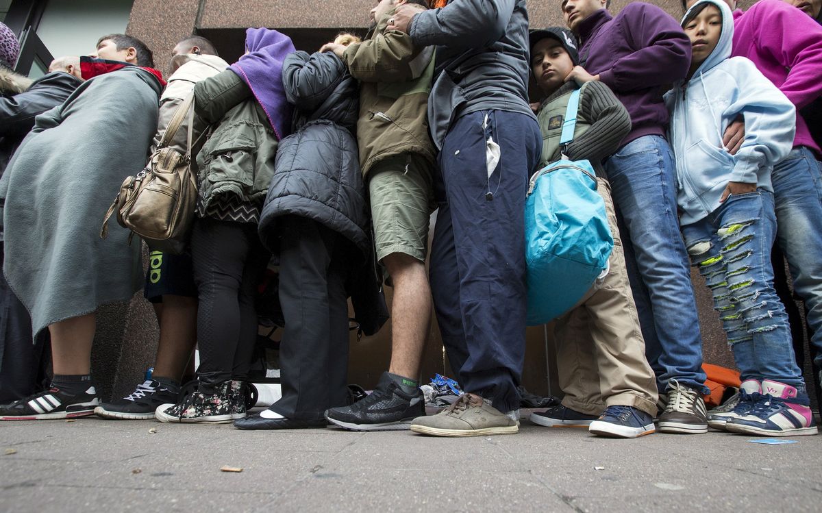 Asylum seekers wait outside the foreign office in Brussels, Belgium.