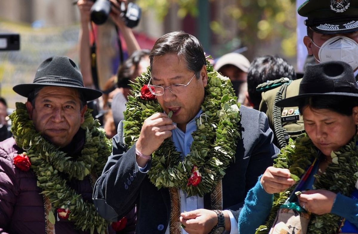 Bolivian Vice President David Choquehuanca and President Luis Arce chew coca leaves during the celebration of the "acullico" tradition, where coca leaves are shared and alternative products made with coca are shown, in La Paz, Bolivia January 11, 2023.