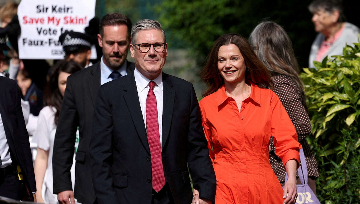 ​Britain's opposition Labour Party leader Keir Starmer and his wife Victoria Starmer walk outside a polling station during the general election in London, Britain, on July 4, 2024. 