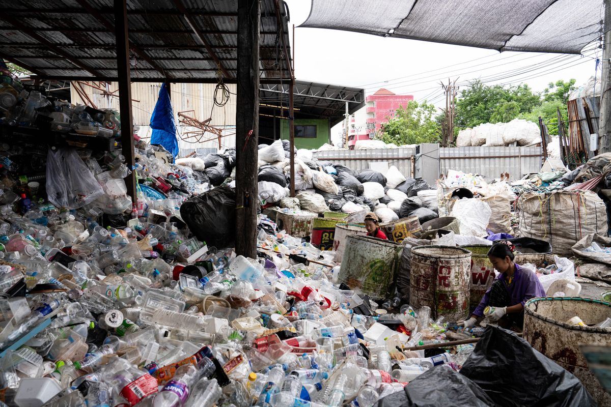 ​Burmese workers are sorting rotting food waste, fabric, and recyclable plastic by hand at a sorting facility in Bangkok, Thailand, on July 22, 2024.