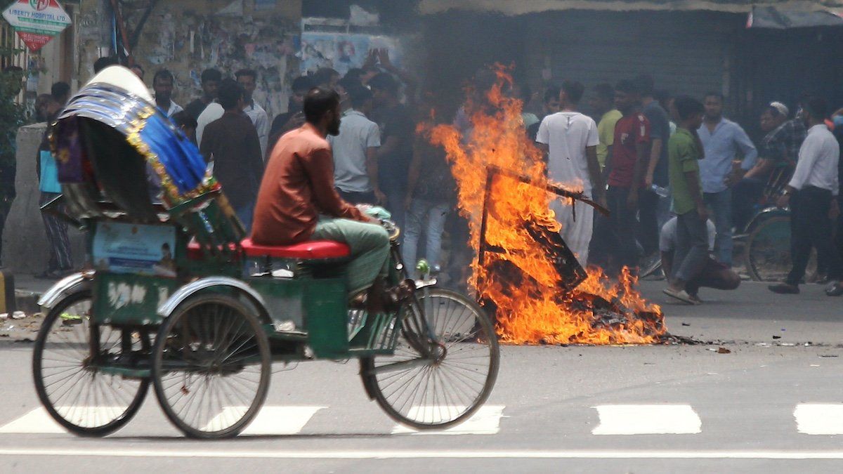 Buses are seen on fire at the Bangabandhu Sheikh Mujib Medical University premises after a clash between students and government supporters during a protest in Dhaka on August 4, 2024. 