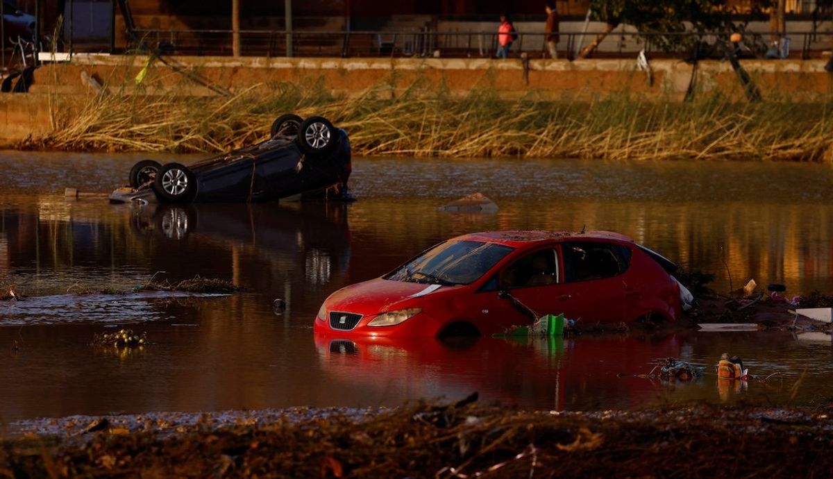 ​Cars lie partially submerged after floods in Utiel, Spain, on Oct. 30, 2024. 