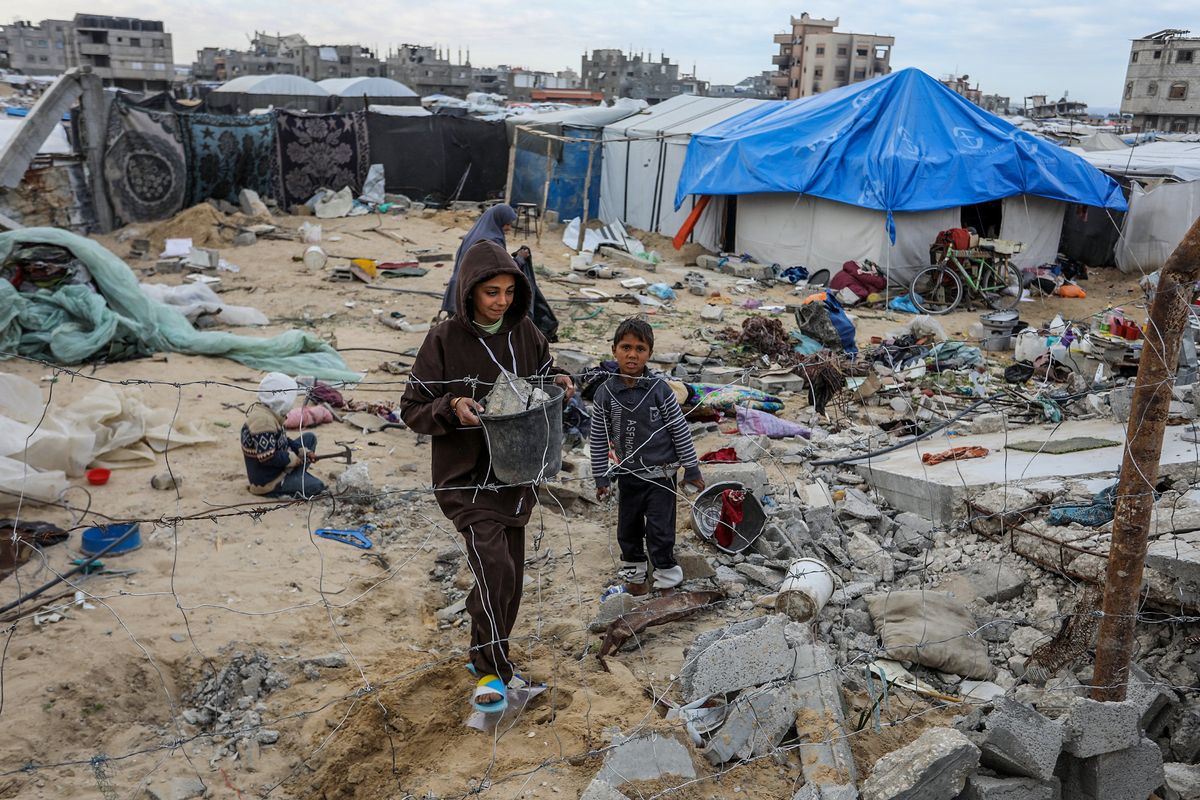 ​Children walk through the destruction, as Palestinians try to build 