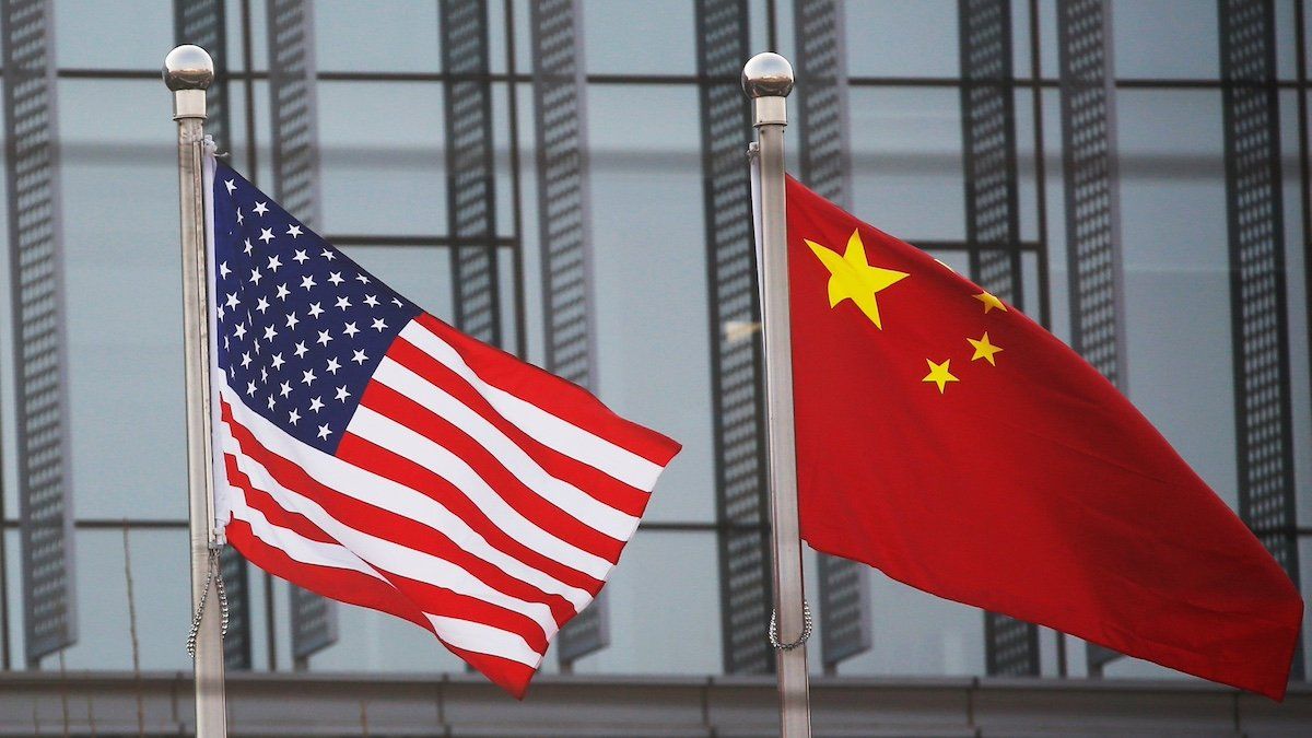 ​Chinese and U.S. flags flutter outside the building of an American company in Beijing, China, January 21, 2021. 