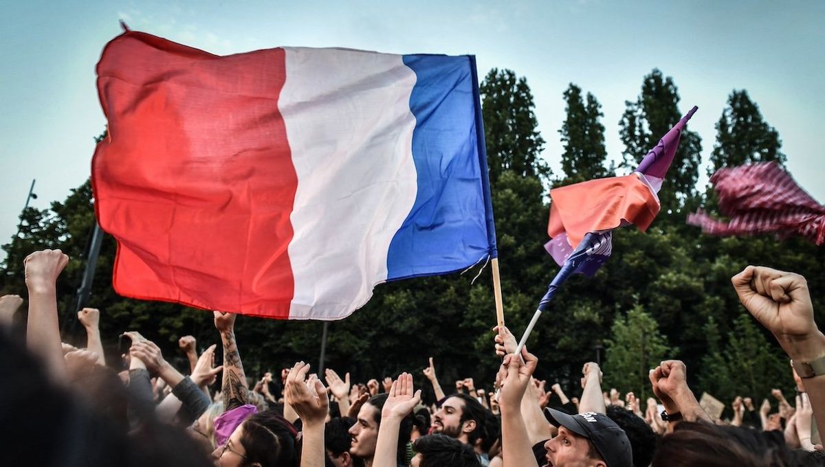 Demonstrators celebrate during the New Popular Front’s election night after announcing the voting primary results for 2nd tour of the French legislative elections, in Paris on July 7, 2024. 