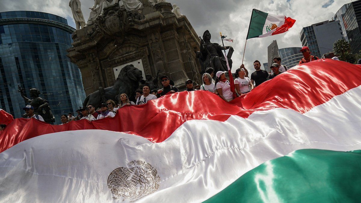 ​Demonstrators display a large Mexico flag as they protest at the Angel of Independence after a highly contested judicial reform proposal was passed in the Senate in Mexico City, Mexico September 11, 2024. 