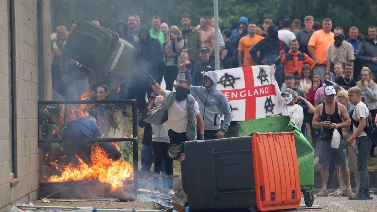 ​Demonstrators toss a trash bin during an anti-immigration protest, in Rotherham, Britain, August 4, 2024. 