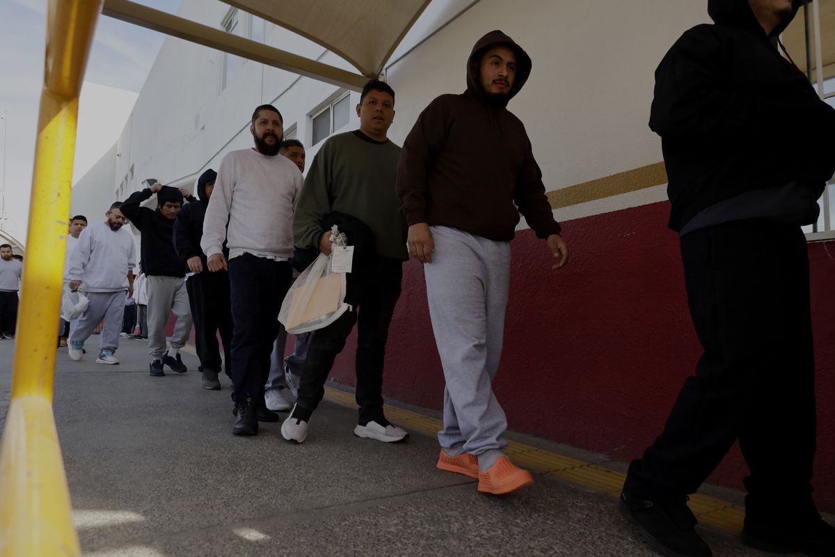 ​Deported migrants are guarded by elements of the National Institute of Migration at the entrance of the Paso del Norte International Bridge in Ciudad Juarez, Mexico, on February 1, 2025, where North American authorities carry out these mass deportations and hand them over to personnel of said institute. 