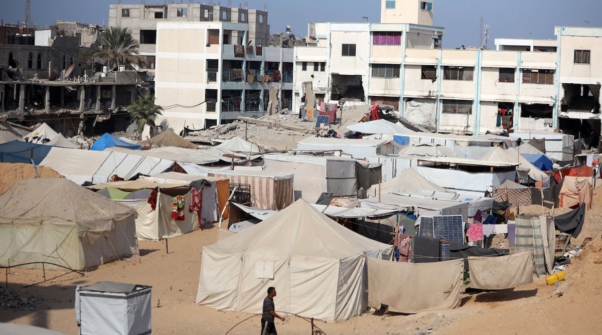 ​Displaced Palestinians walk in a tent camp amid the conflict between Israel and Hamas in Khan Younis, southern Gaza Strip, on Nov. 9, 2024. 