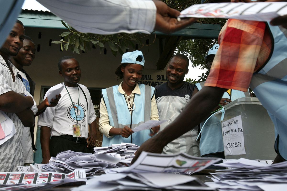 ​Electoral Committee staff laugh as they count votes for Ghana's general election at the end of a day of polling in Accra, December 7, 2008. Ghanaians voted in large numbers on Sunday to choose between two foreign-trained lawyers hoping to lead them into an era of oil-funded prosperity in a tight poll that may set an example for African democracy. 