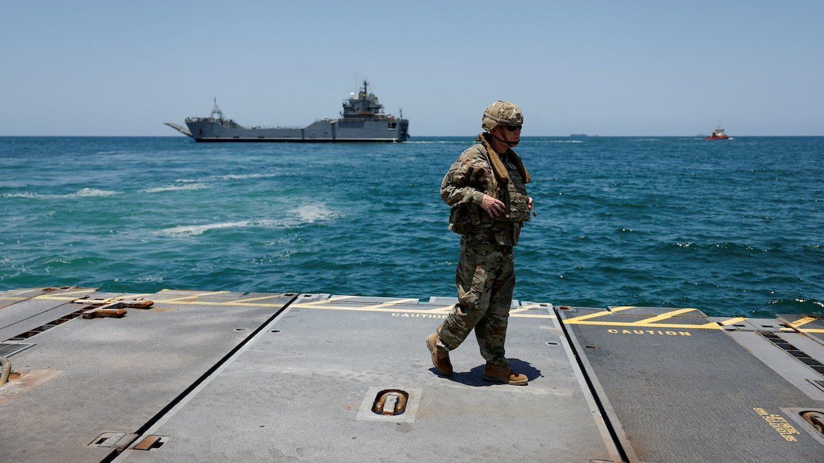 ​FILE PHOTO: A soldier stands at Trident Pier, a temporary pier to deliver aid, off the Gaza Strip, amid the ongoing conflict between Israel and Hamas, near the Gaza coast, June 25, 2024. 