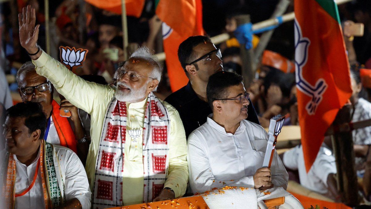 FILE PHOTO: India's Prime Minister Narendra Modi waves towards his supporters during a roadshow as part of an election campaign, in Kolkata, India, May 28, 2024. 