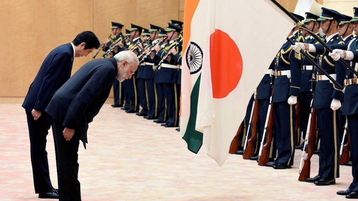 FILE PHOTO: Indian Prime Minister Narendra Modi (2nd L) and his former Japanese counterpart Shinzo Abe (L) bow to national flags as they review an honor guard before their meeting at Abe's official residence in Tokyo, Japan November 11, 2016. 