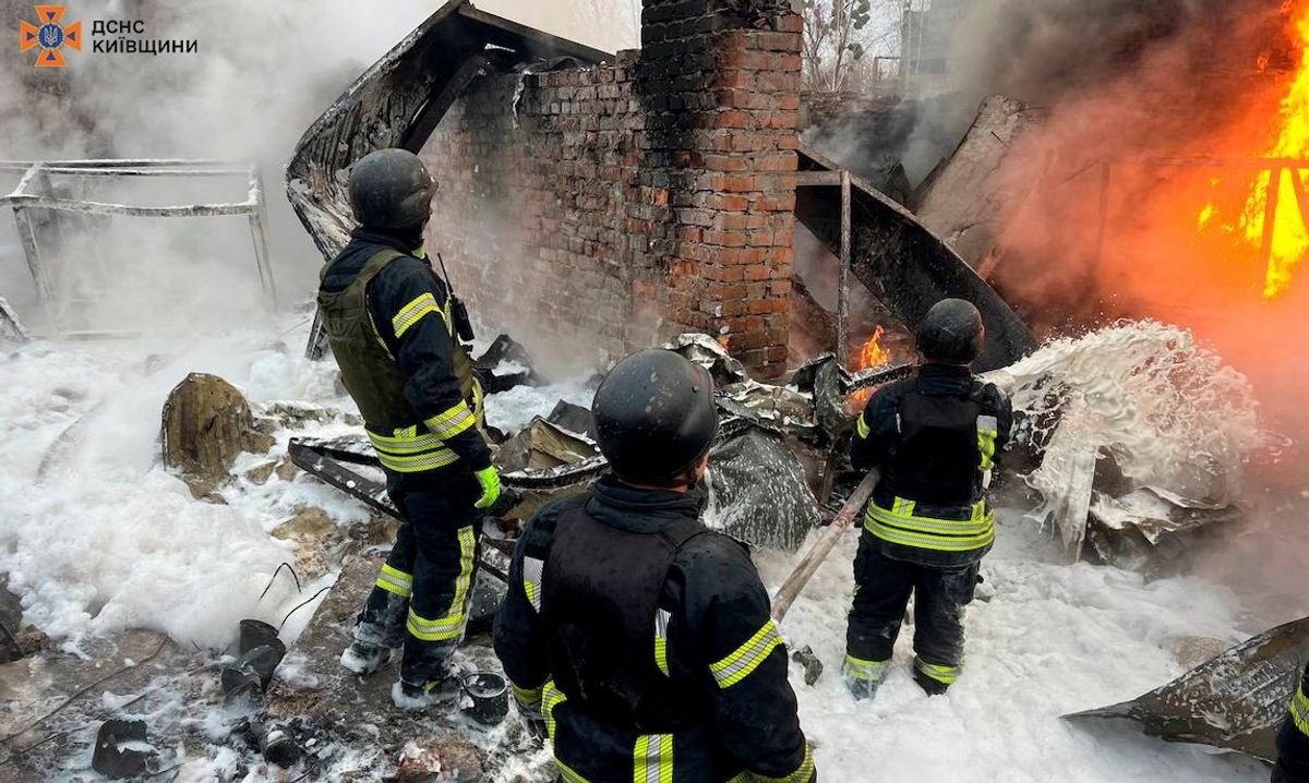 ​Firefighters work at the site where an industrial area was hit by a Russian missile strike in the Kyiv region on Nov. 13, 2024. 