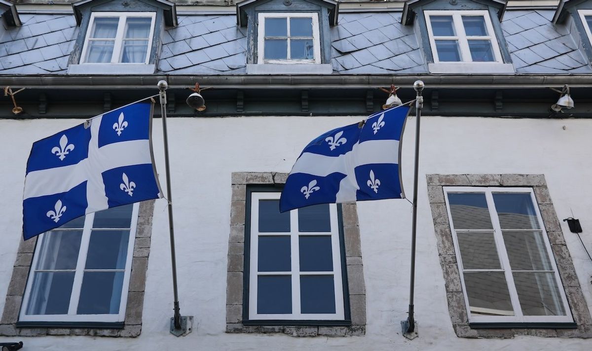 ​Flags of Quebec are seen on the building in Quebec City, Canada, in 2023.