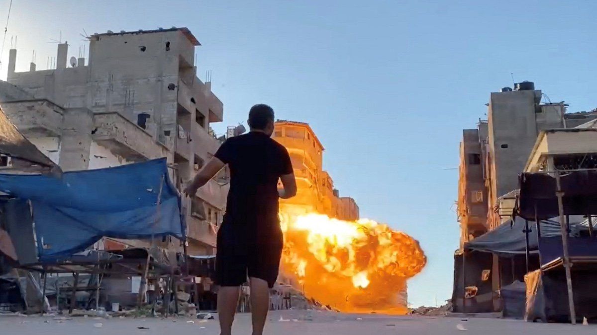 Flames rise following an Israeli strike on a residential building, amid the ongoing conflict between Israel and Hamas, in Gaza City, in this screen grab taken from a video, August 11, 2024. 