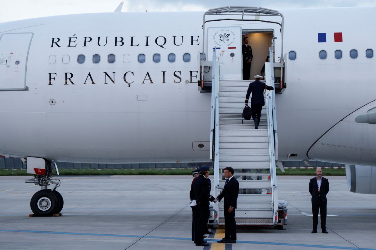 ​France's President Emmanuel Macron shakes hands with crew members before boarding his Presidential plane to travel to the Pacific archipelago of New Caledonia in an attempt to resolve a political crisis, at the Orly airport, a suburb of Paris on May 21, 2024. 