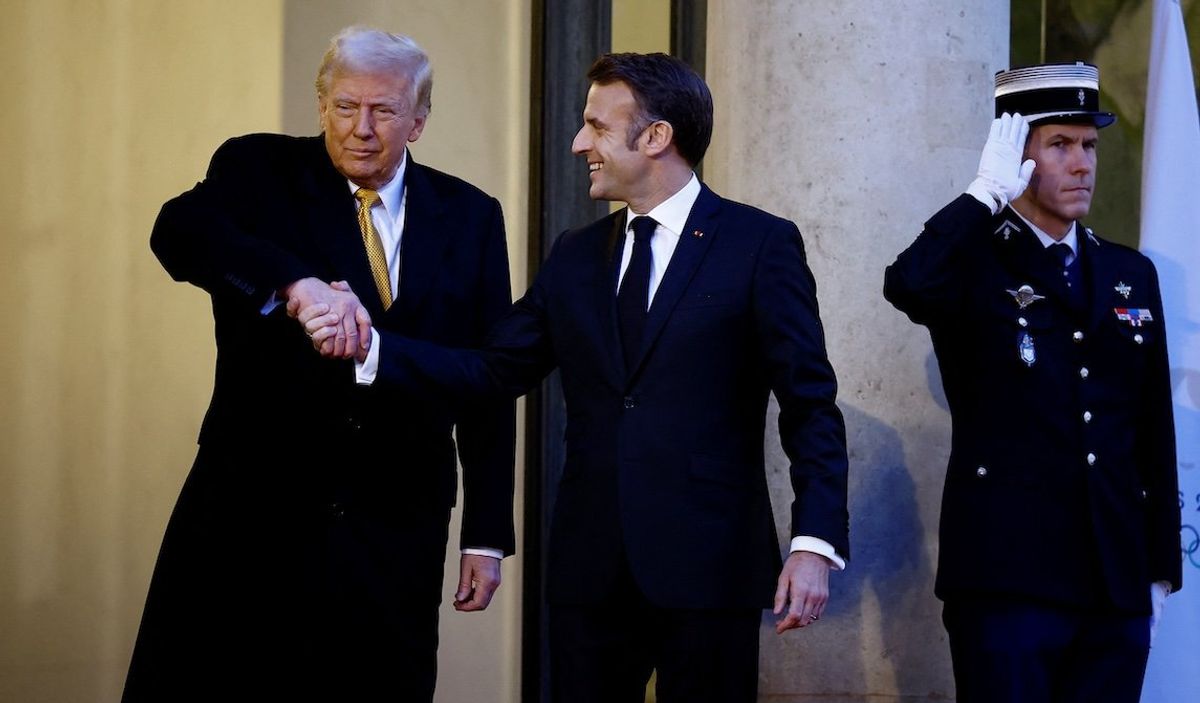 ​French President Emmanuel Macron shakes hands with US President-elect Donald Trump as he arrives for a meeting at the Elysee Palace in Paris as part of ceremonies to mark the reopening of the Notre-Dame de Paris Cathedral, in Paris, on Dec. 7, 2024.