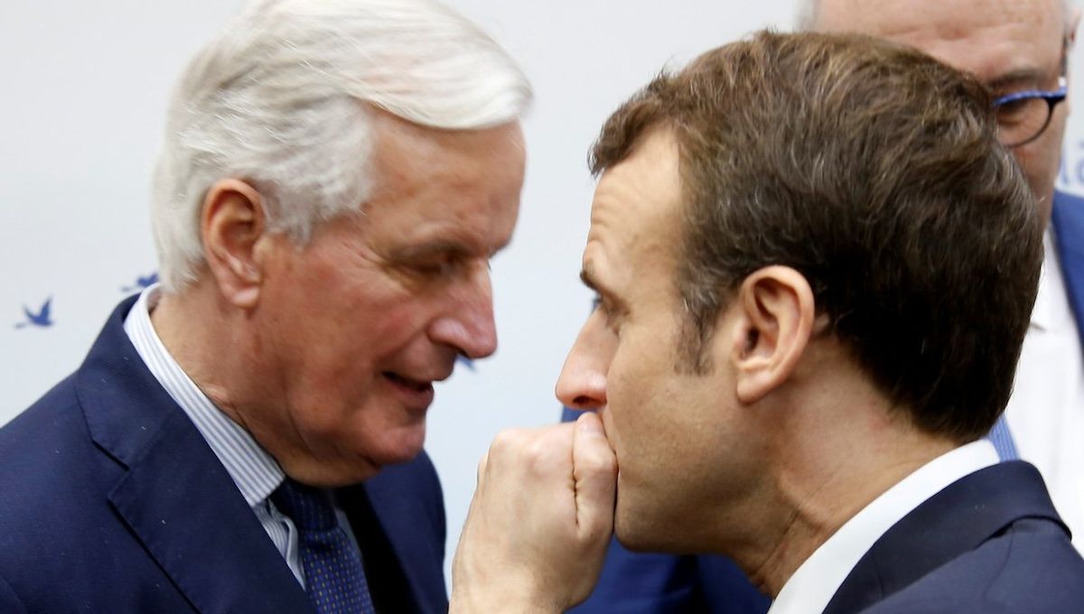 ​French President Emmanuel Macron speaks with then-EU Chief Brexit Negotiator Michel Barnier in February 2019.