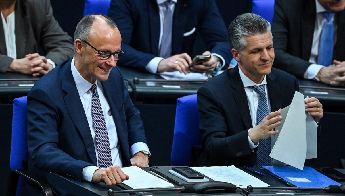 ​Germany's chancellor-in-waiting and leader of the Christian Democratic Union party Friedrich Merz reacts as he attends an extraordinary session of the outgoing lower house of parliament, the Bundestag, on March 18, 2025. 