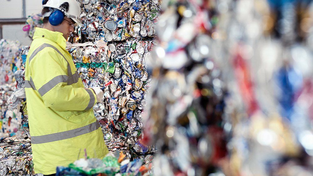 Person looking at a landfill of reusable cans