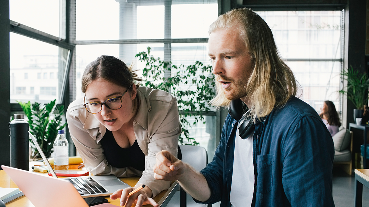 Two people working with their laptops