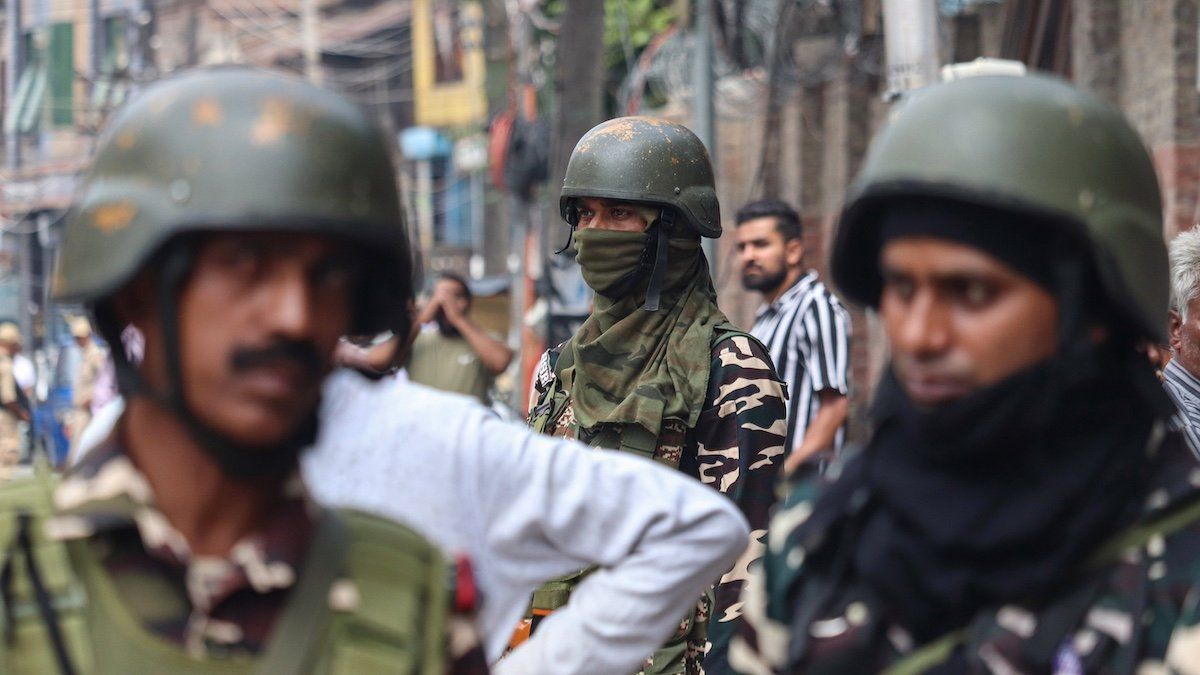 ​Indian paramilitary soldiers stand alert while Jammu and Kashmir National Conference candidate Mubarak Gul arrives to file his nomination papers for assembly elections in Srinagar, Jammu and Kashmir, on September 2, 2024. 