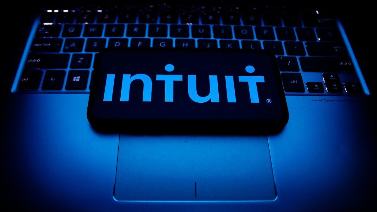 Intuit logo displayed on a phone screen and a laptop keyboard are seen in this illustration photo taken in Krakow, Poland on October 30, 2021.