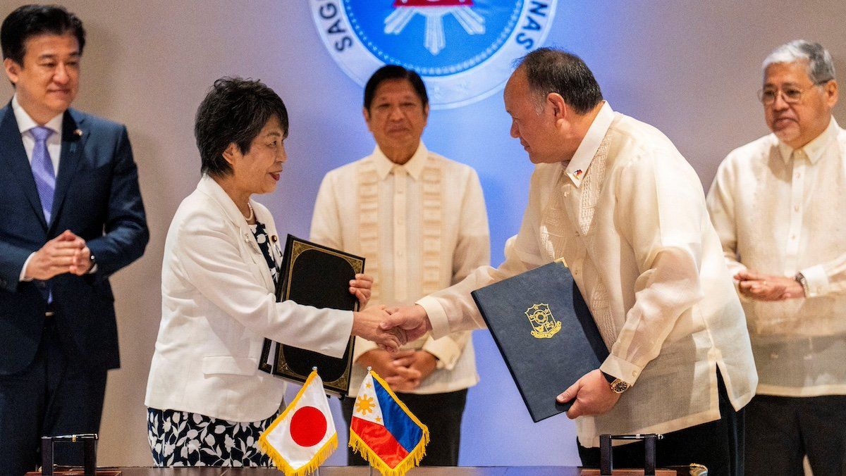 Japan's Foreign Minister Yoko Kamikawa and Philippine's Defence Minister Gilberto Teodoro shake hands after signing the reciprocal access agreement, at the Malacanang Palace in Manila, Philippines, July 8, 2024. 