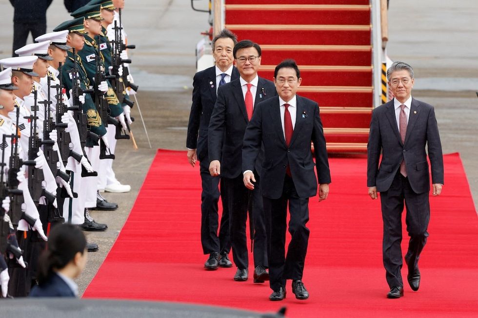 ​Japanese Prime Minister Fumio Kishida arrives to attend the trilateral summit with his South Korean and Chinese counterparts in Seoul, South Korea. 