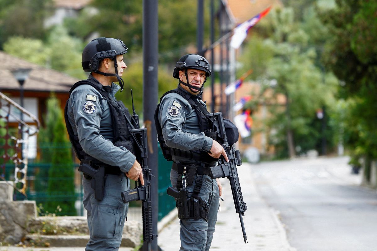 Kosovo police officers patrol, in the aftermath of a shooting incident