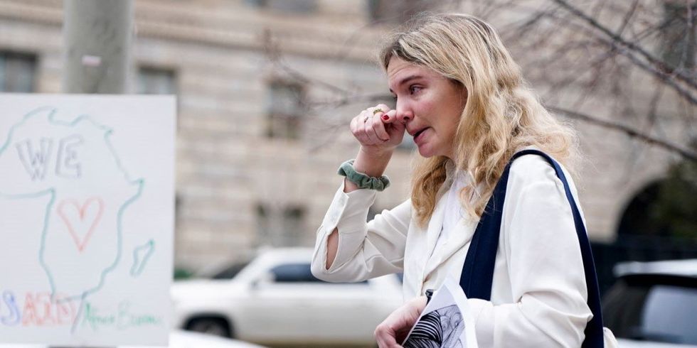 Laid-off U.S. Agency for International Development (USAID) probationary employee Juliane Alfen reacts after USAID workers cleared out their desks and collected personal belongings, during a sendoff in Washington, D.C., U.S., February 27, 2025.]